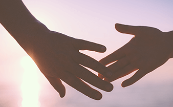 Two hands holding each other.